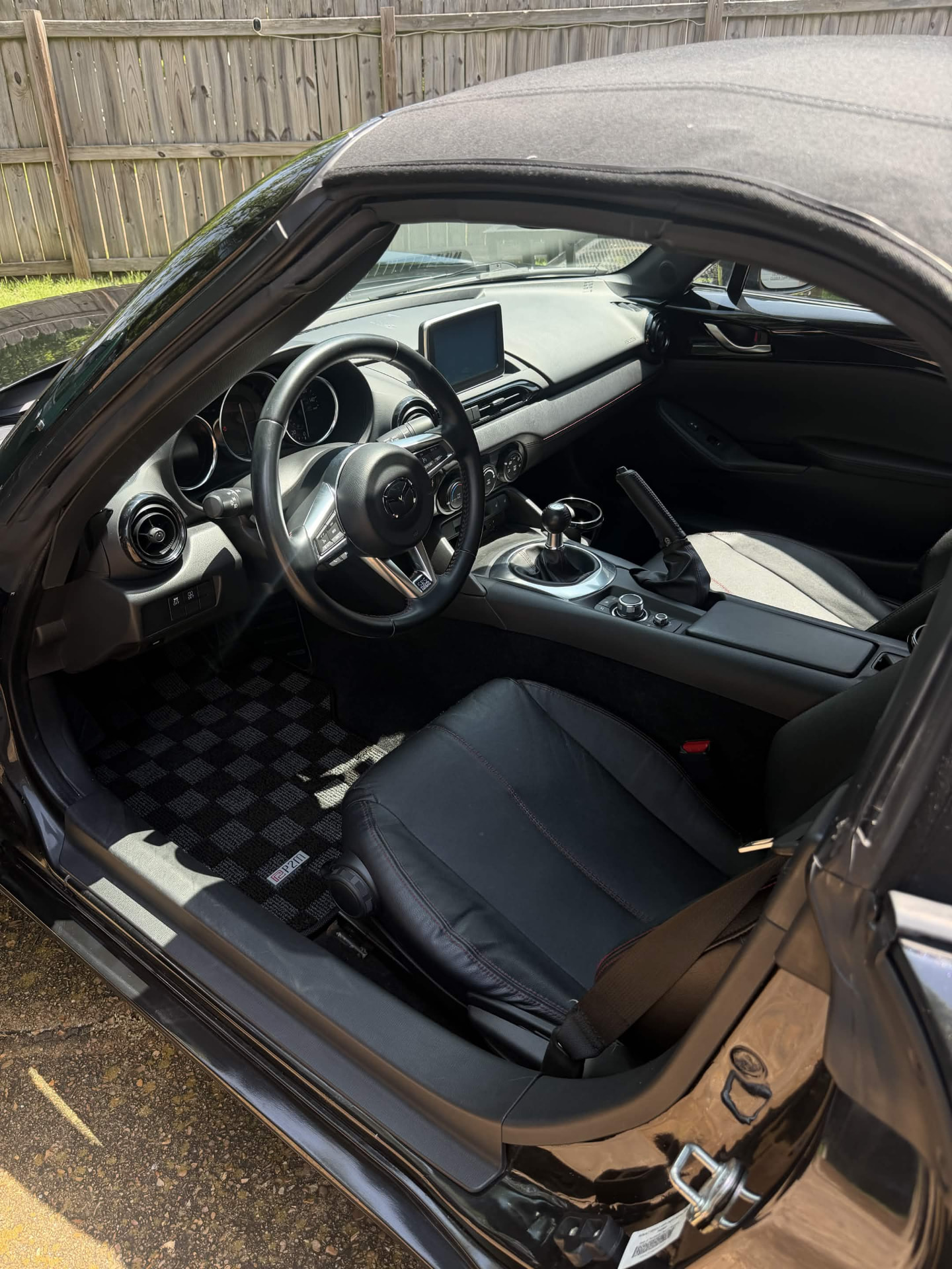 Miata cockpit deep-cleaned and conditioned — dashboard, leather seats, sills, and carpet.